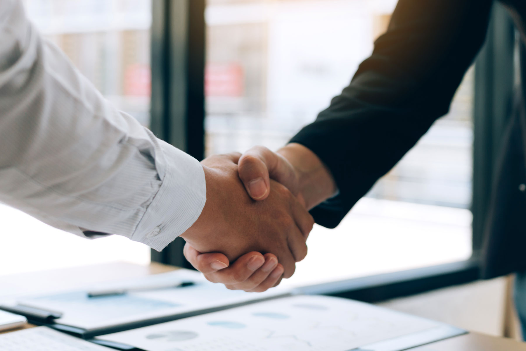 two people shake hands after talking about the joint commission