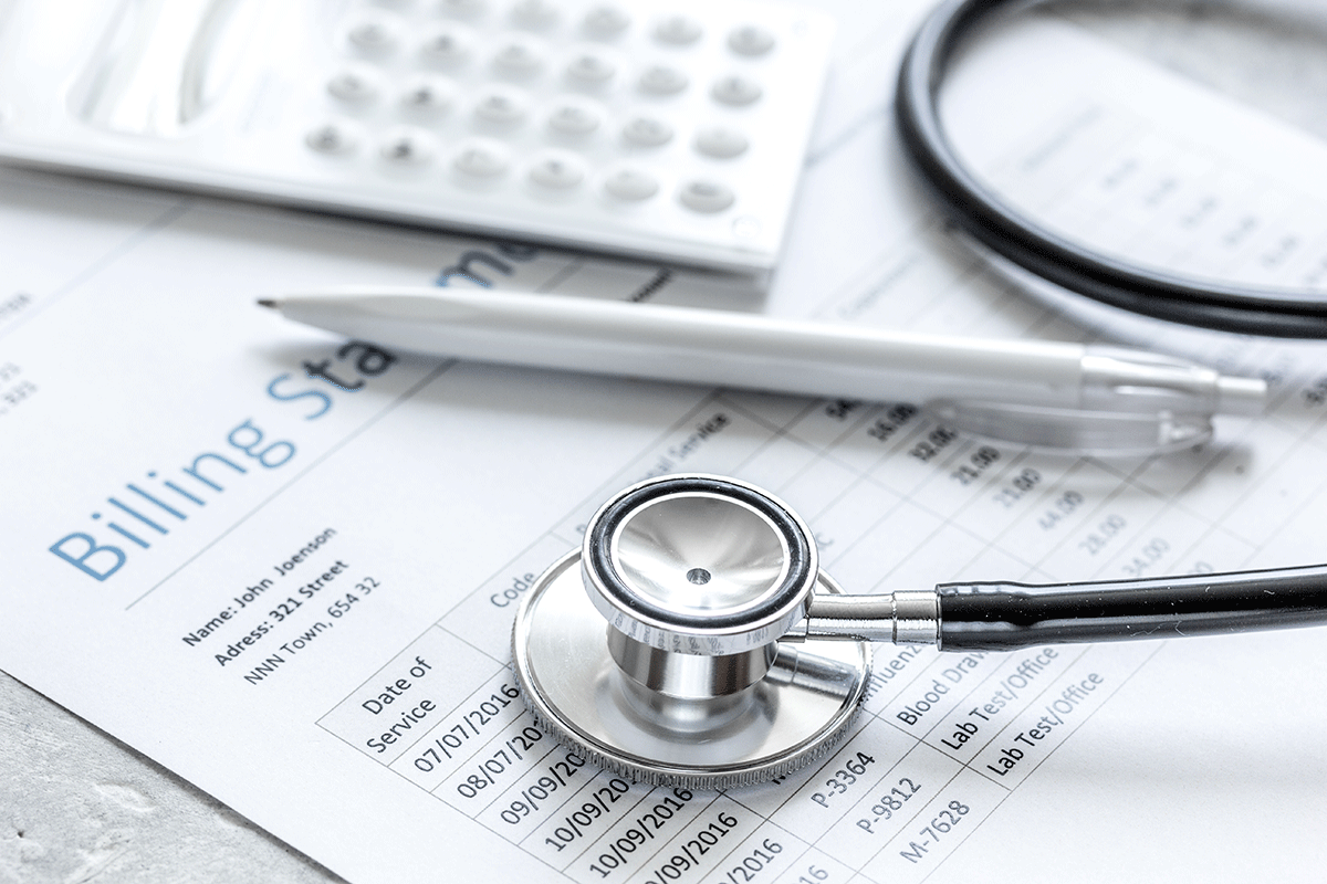a stethoscope lies on top of papers about measuring the performance of your revenue cycle