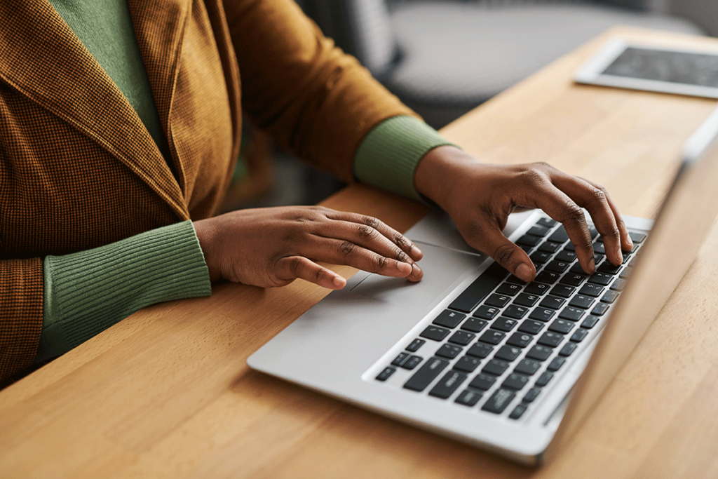 a person uses a computer to research the benefits of crm for addiction treatment centers