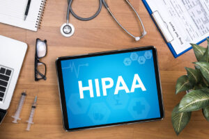 a tablet with the word "HIPAA" stresses the importance of protecting patient privacy