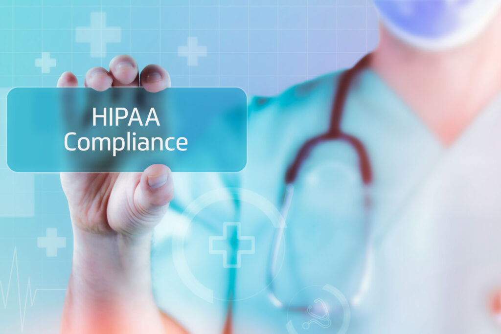 a doctor holds a digital sign that says "HIPAA compliance"