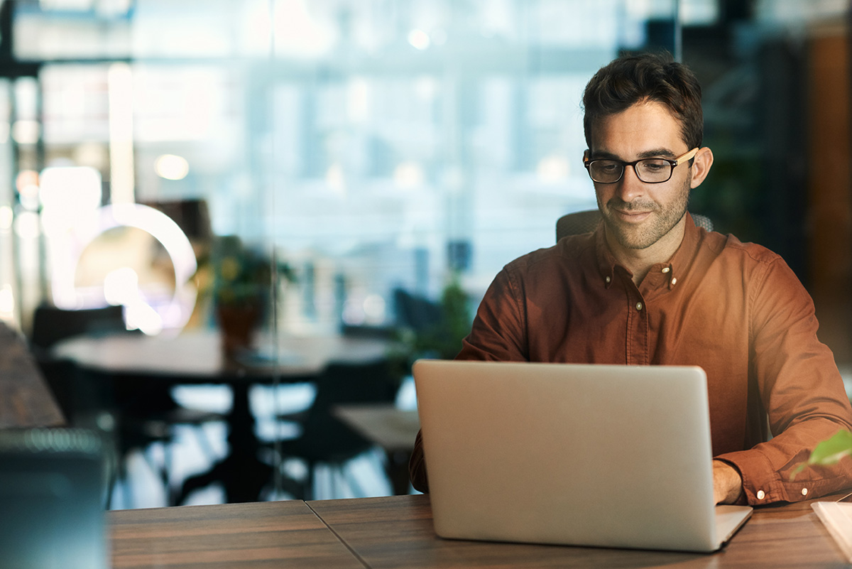 a man uses a computer to research electronic medical records compliance