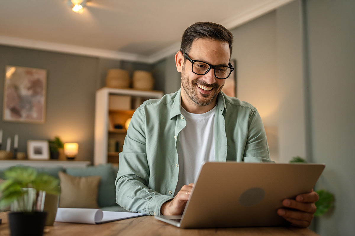 a man uses a laptop to research electronic medical records pros and cons