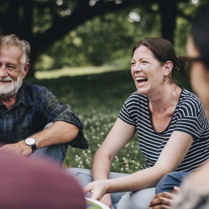 Cheerful woman in the park with her friends