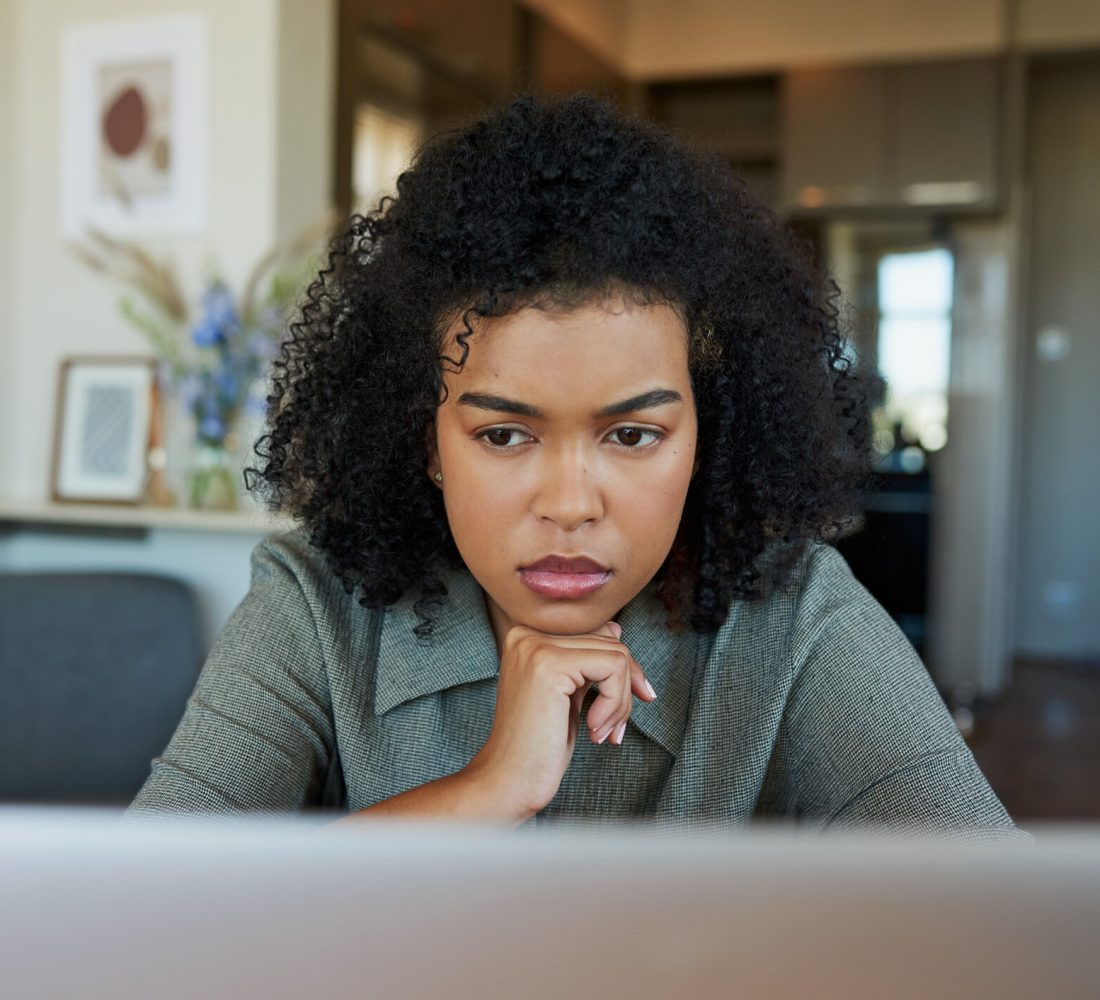 Shot of a young woman using a laptop at home