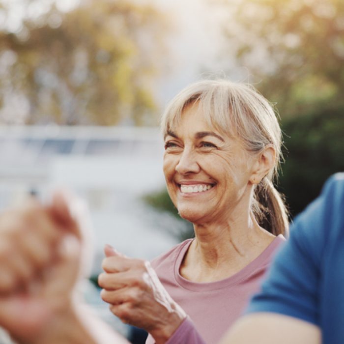 Senior woman, exercise and group in garden at retirement village, health and fitness class in morning. Elderly people, workout and diversity with cardio training, excited and wellness in summer