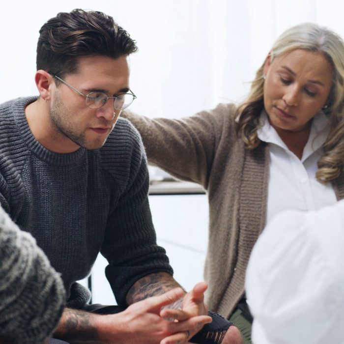 Support group, empathy and sad man in therapy for mental health, hope or healing depression. Psychology, comfort people and counseling with kindness, help and care with trauma in community center
